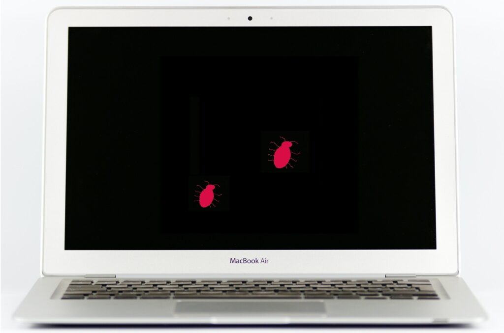 dwa malinowe paintowe robaki na czarnym ekranie Macbooka